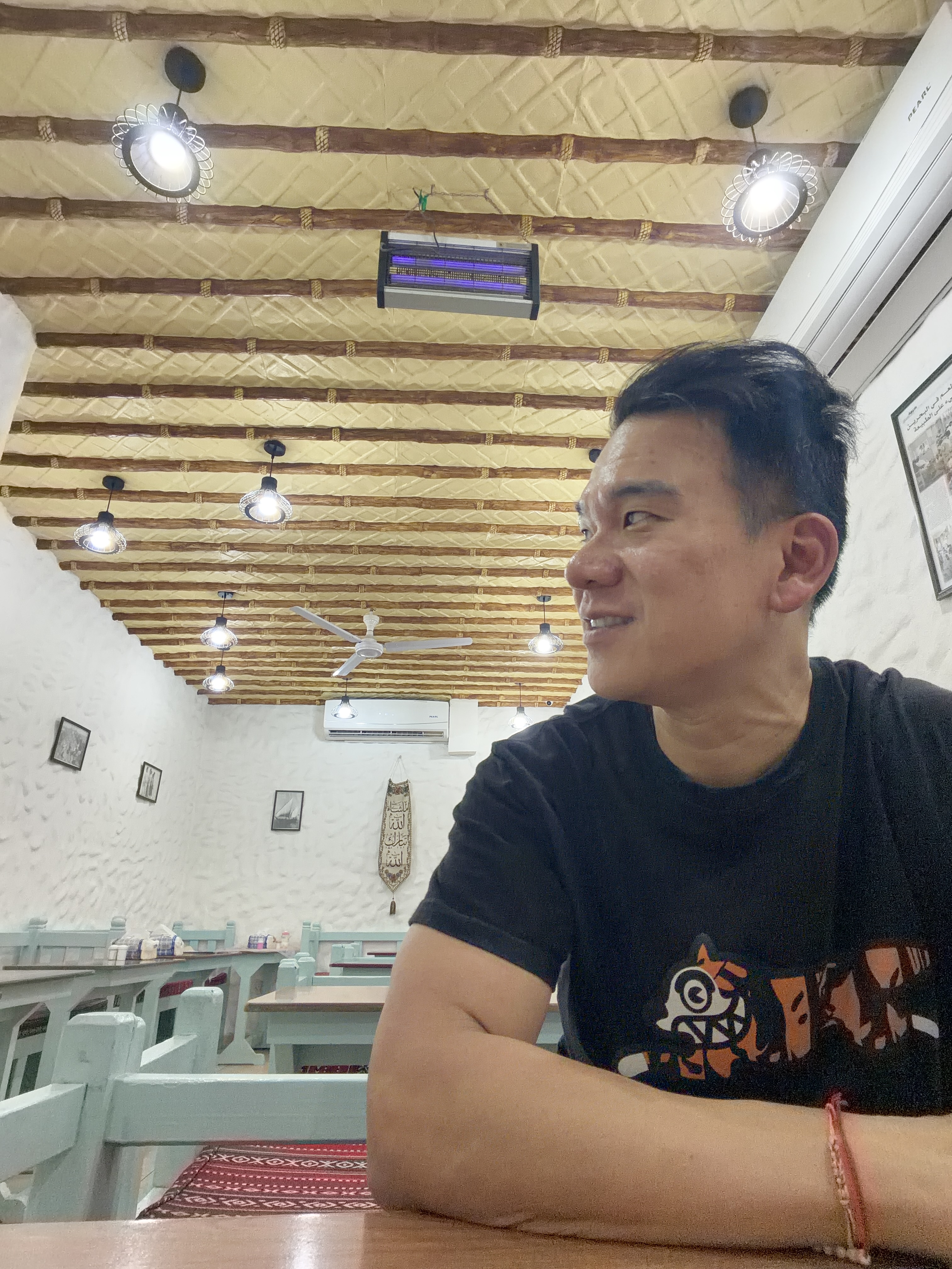 Seated inside Haji's Cafe beneath its traditional wood-beamed ceiling