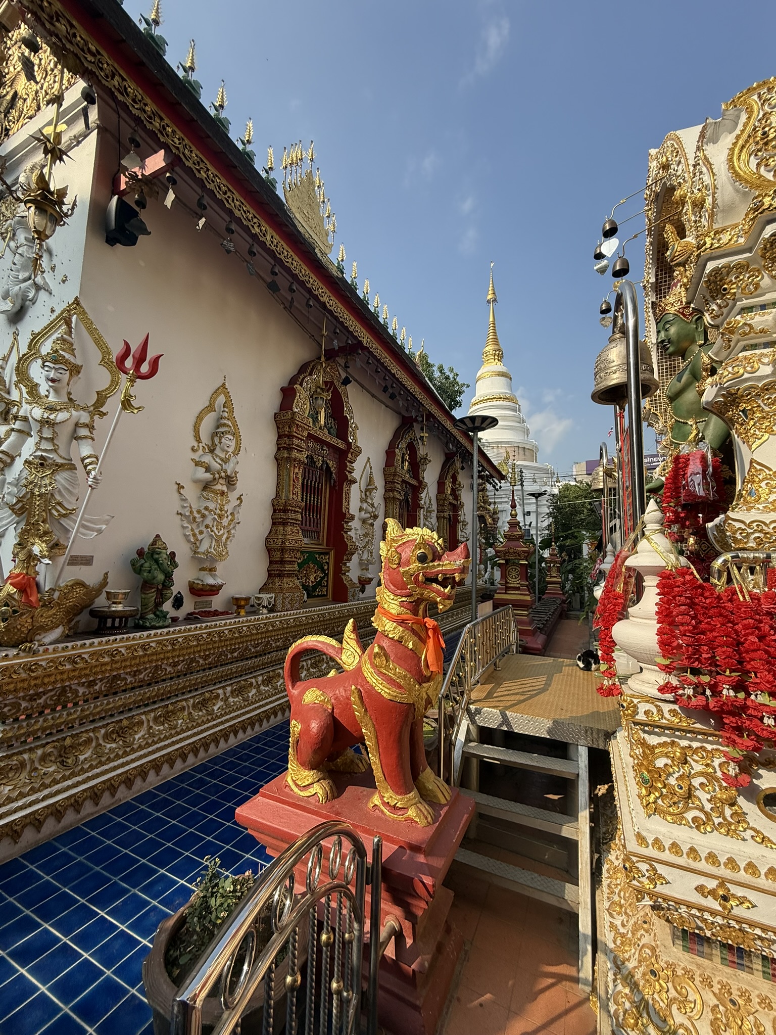 Ornate Thai temple with golden decorations and guardian statues