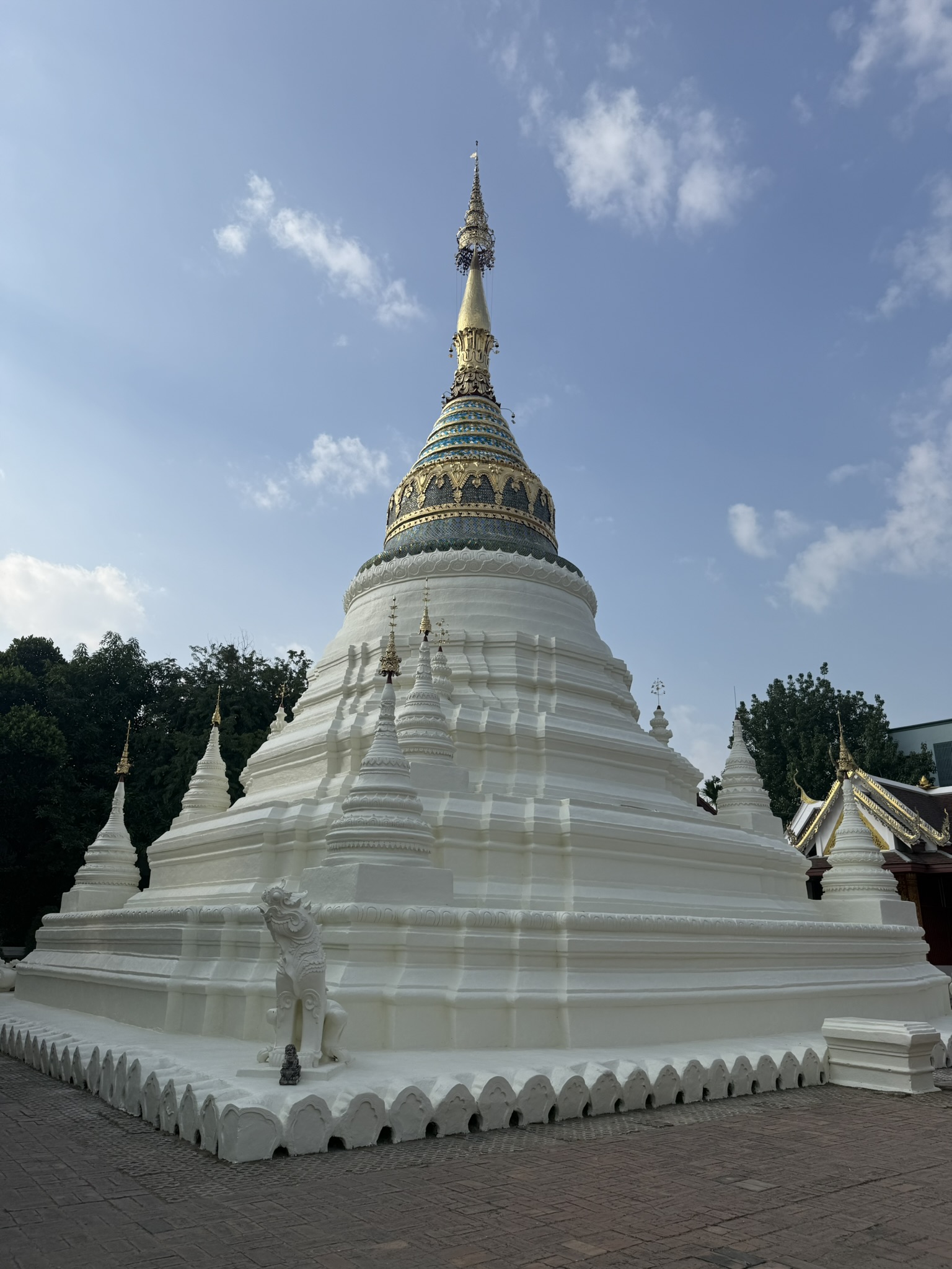 A white Buddhist stupa with golden spire in Chiang Mai