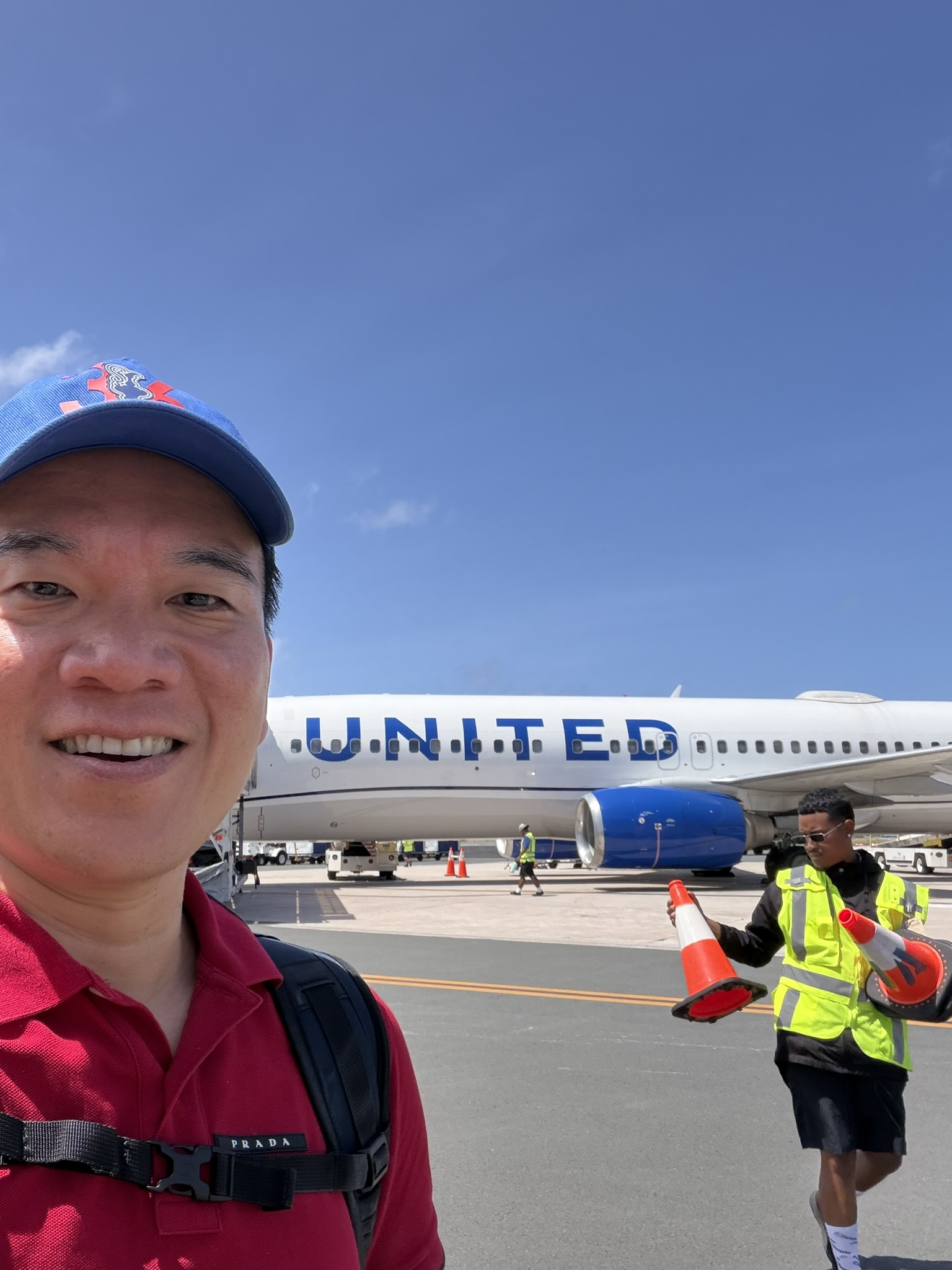 Andrew with United plane on tarmac at Majuro