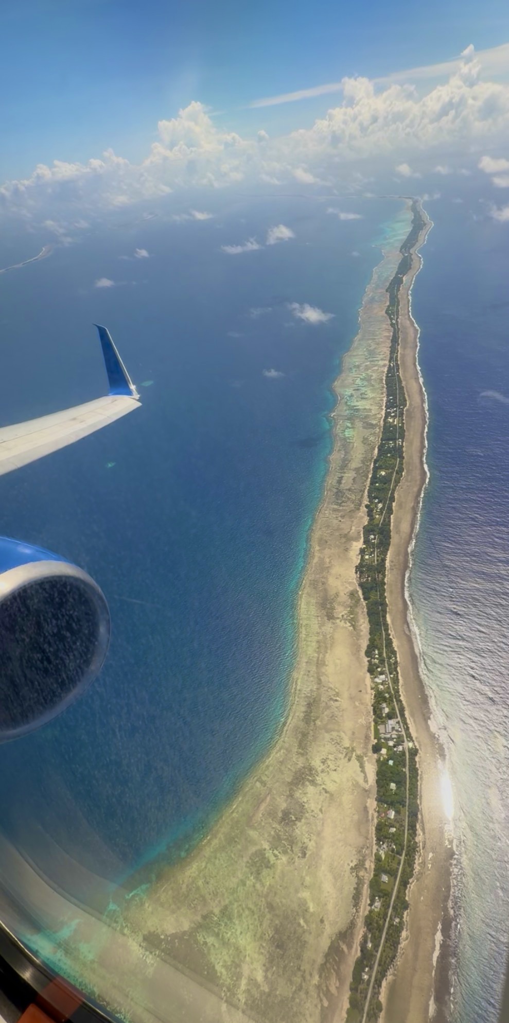 View from plane window of Majuro atoll with United wing visible