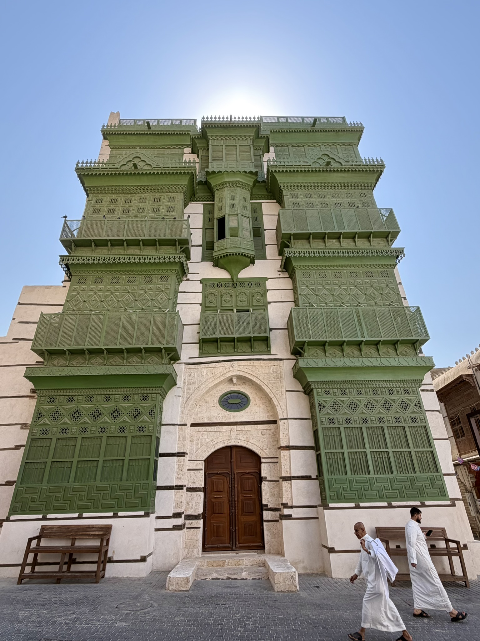 Magnificent green building with intricate wooden balconies in Al Balad