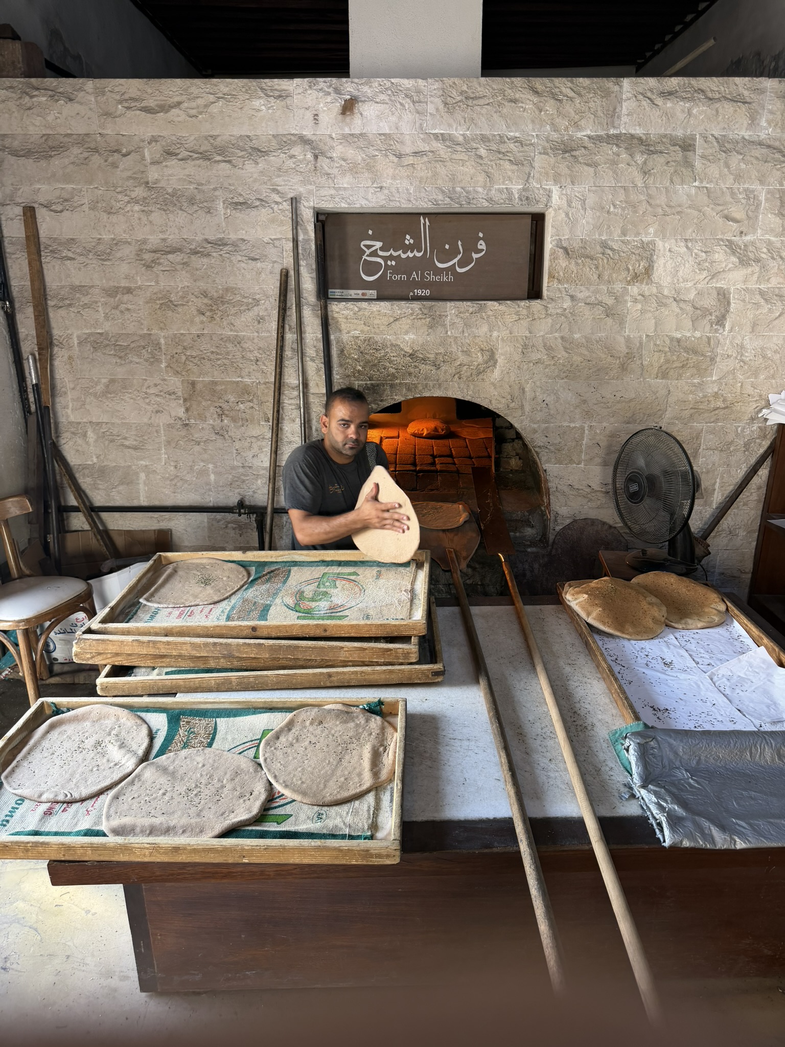 Baker preparing flatbread at Furn Al Sheikh bakery