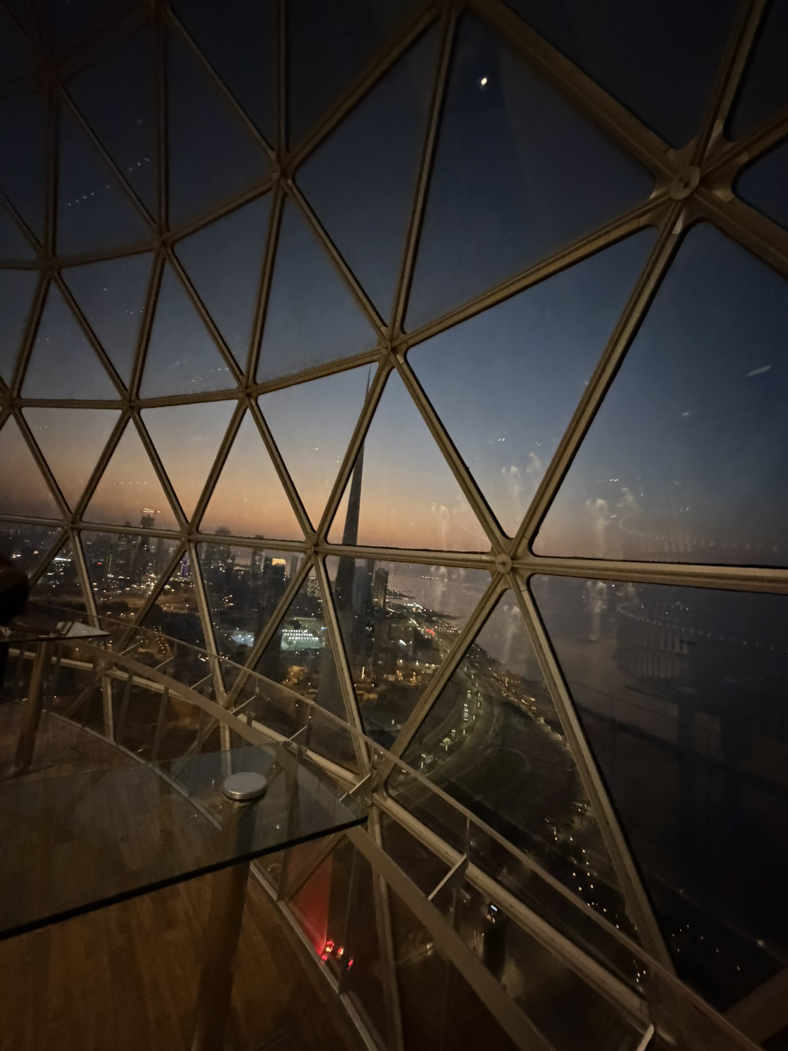 City view through the triangular glass panels of the Kuwait Towers dome