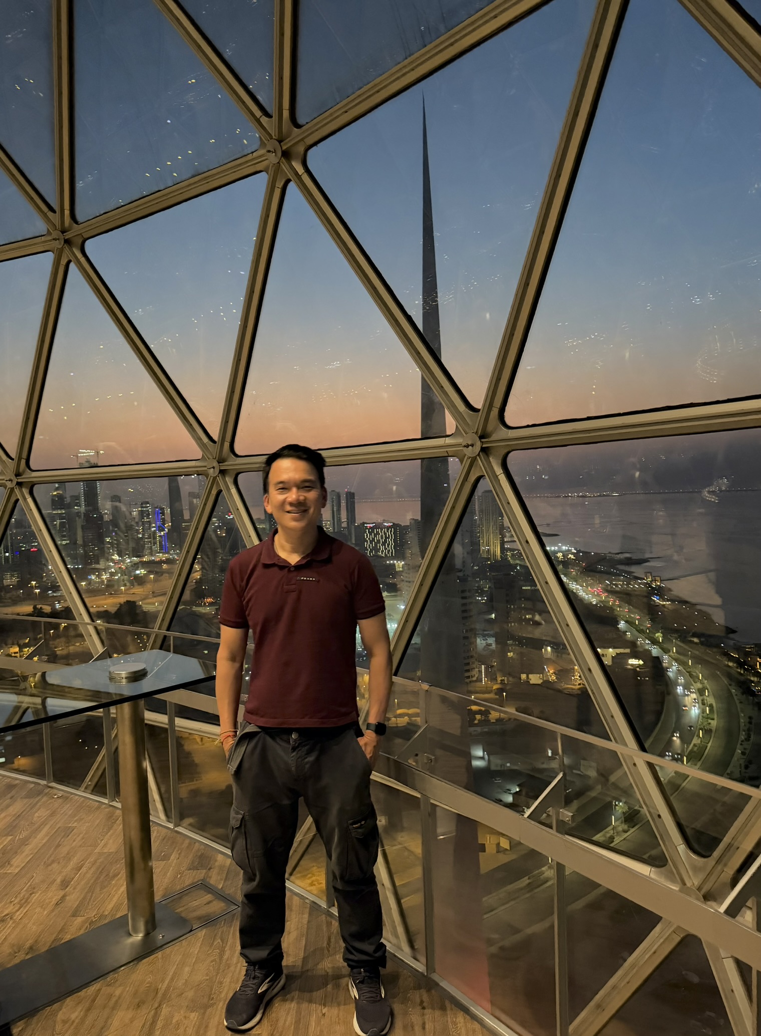Standing inside the Kuwait Towers dome with the sunset skyline behind