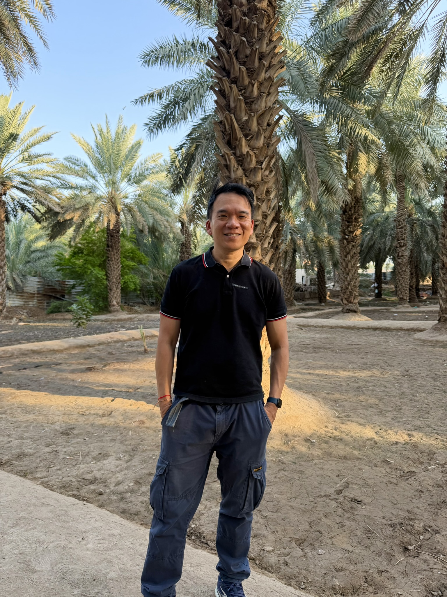 Standing in the date palm garden near the Well of Salman al-Farsi