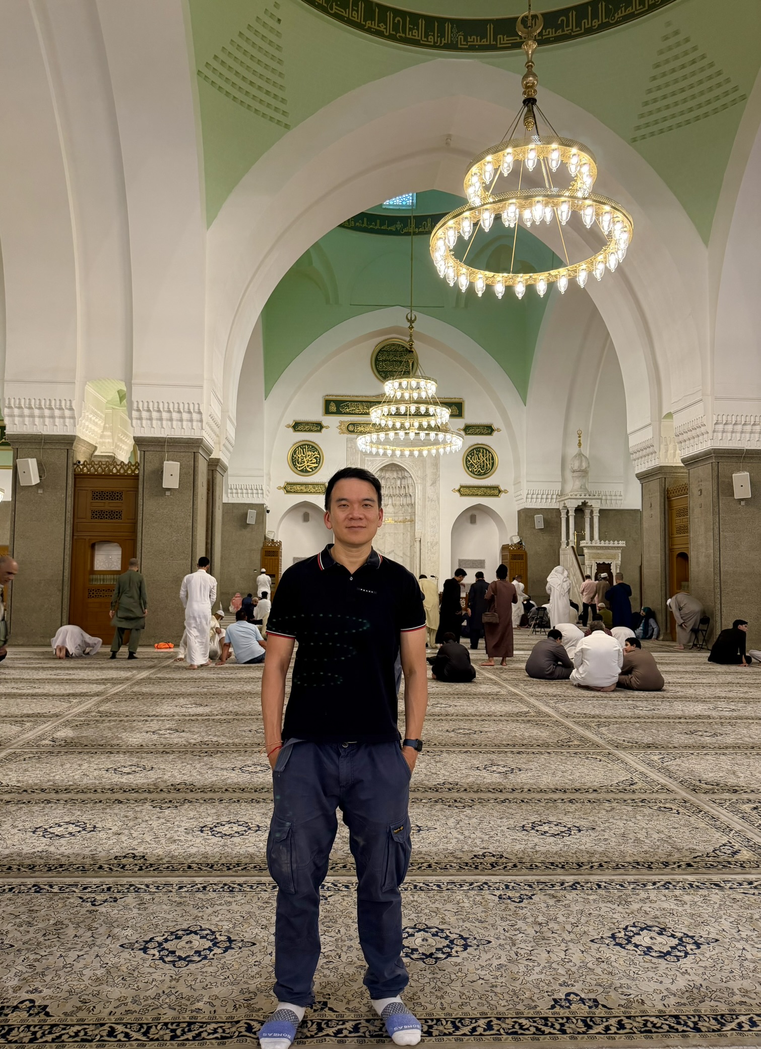 Inside Quba Mosque showing ornate chandeliers