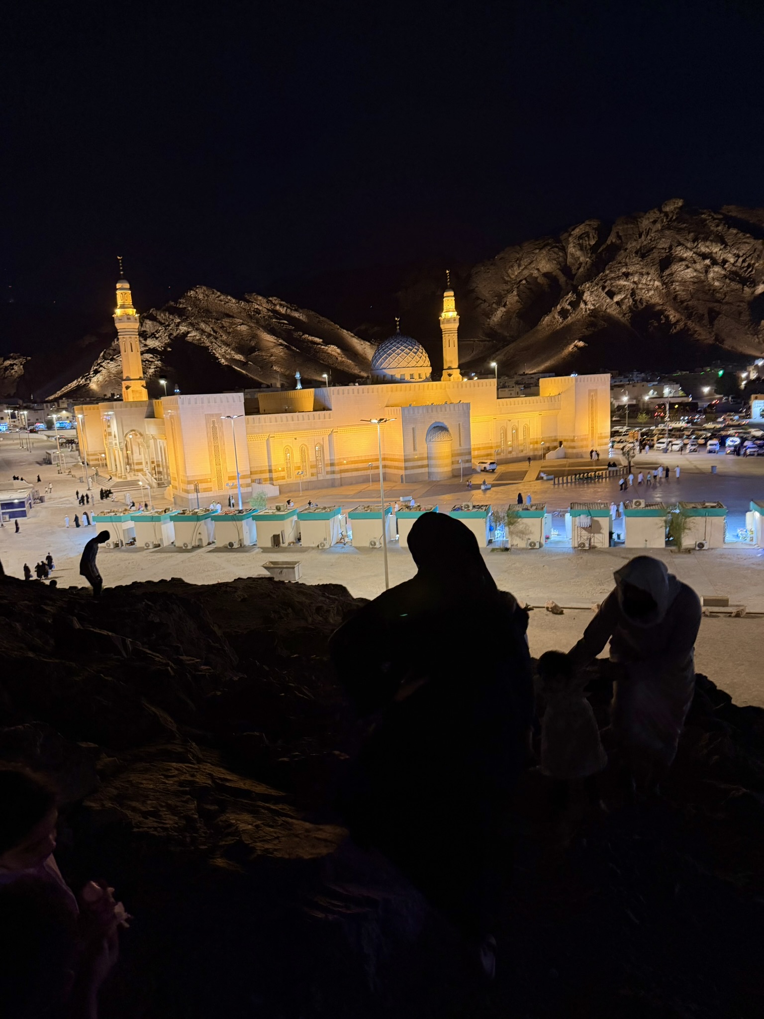 Mount Uhud area at night with illuminated mosque