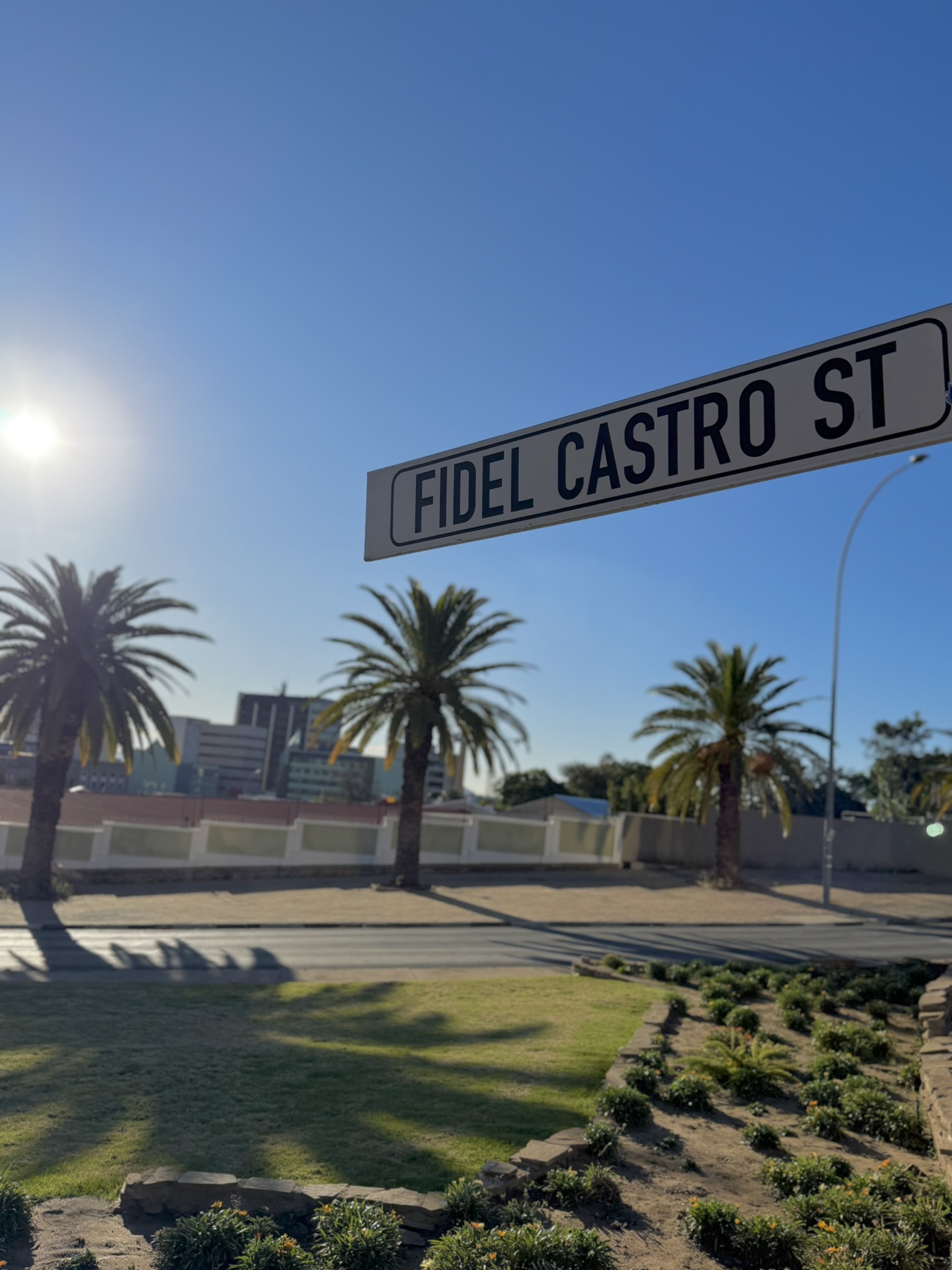 Fidel Castro Street sign in Windhoek with palm trees