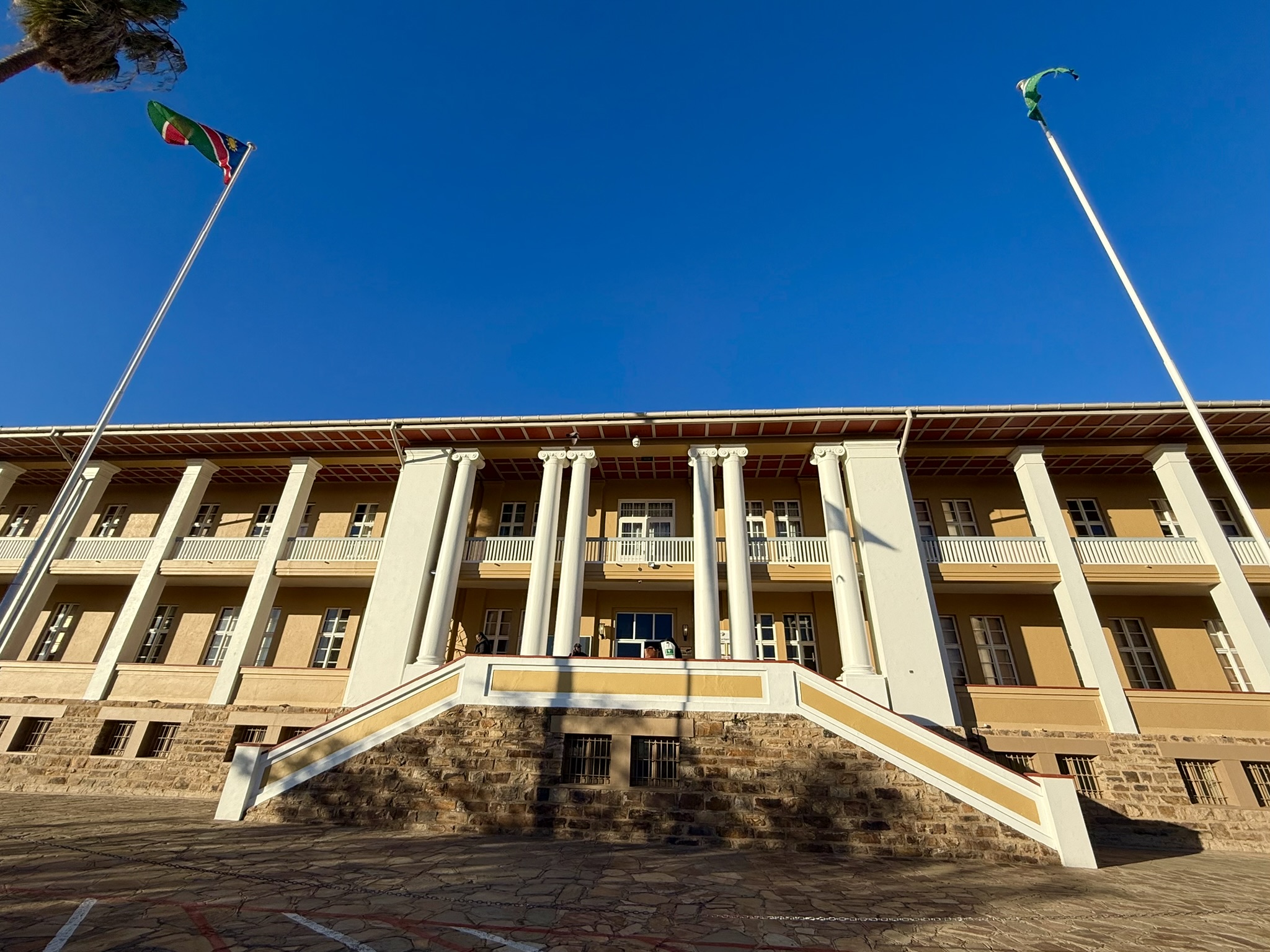 Colonial building with Namibian flags - Alte Feste