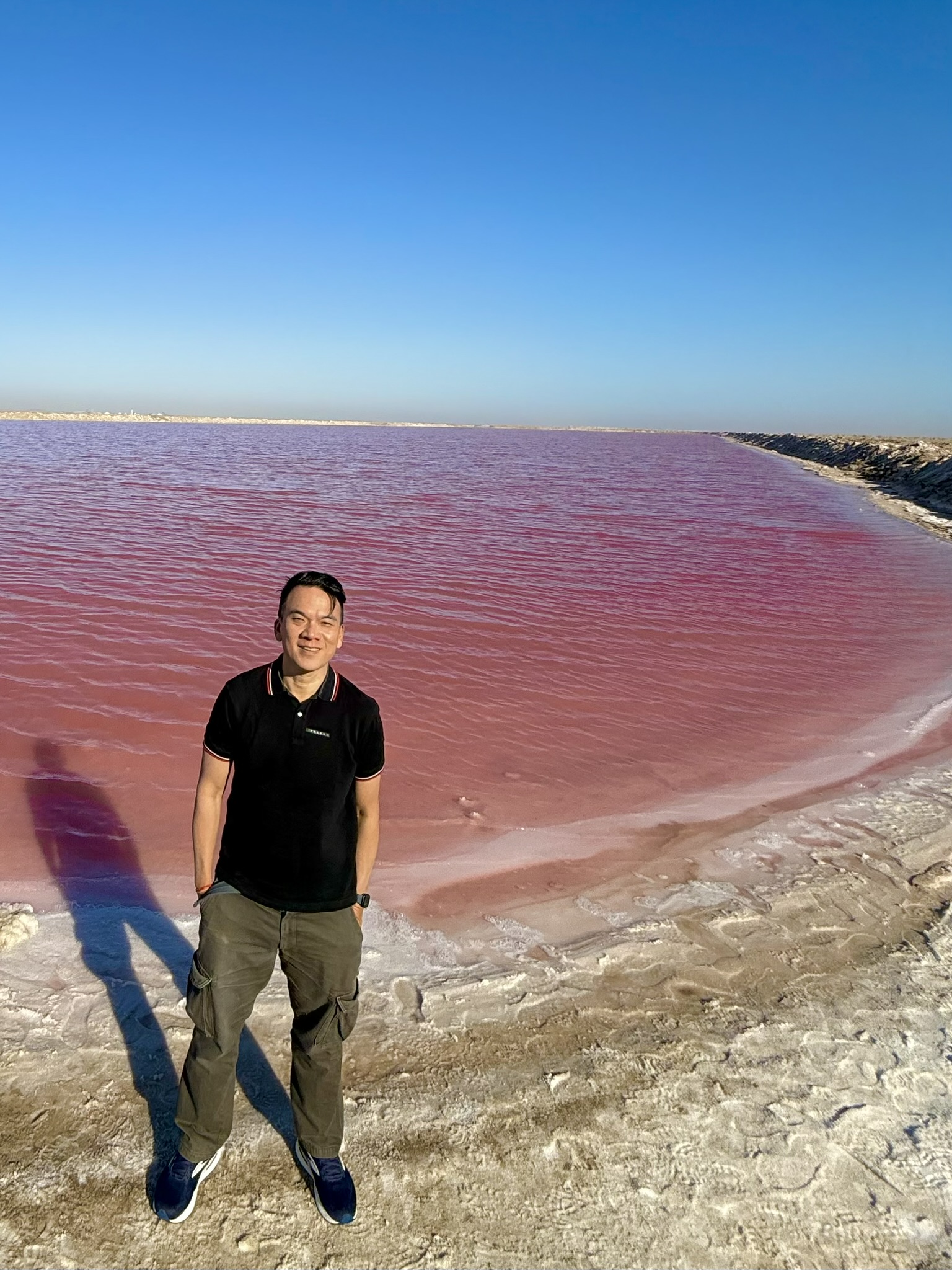 Standing by the pink lake caused by algae and salt concentrations
