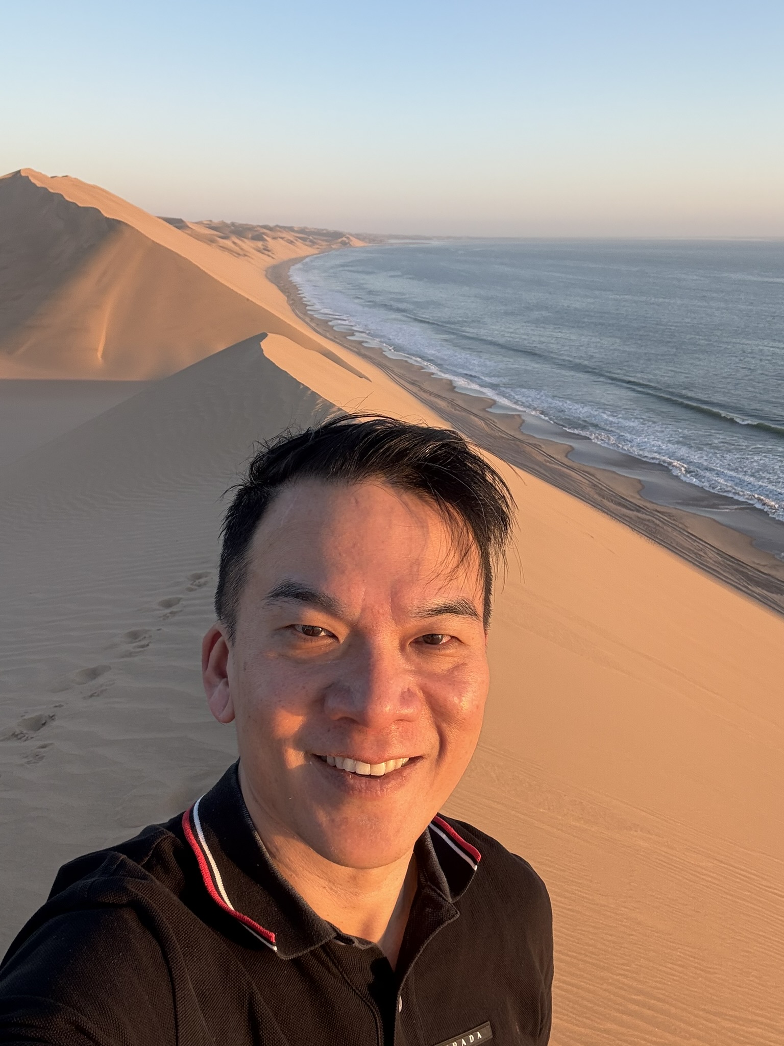 Selfie at Sandwich Harbour with dunes and ocean behind