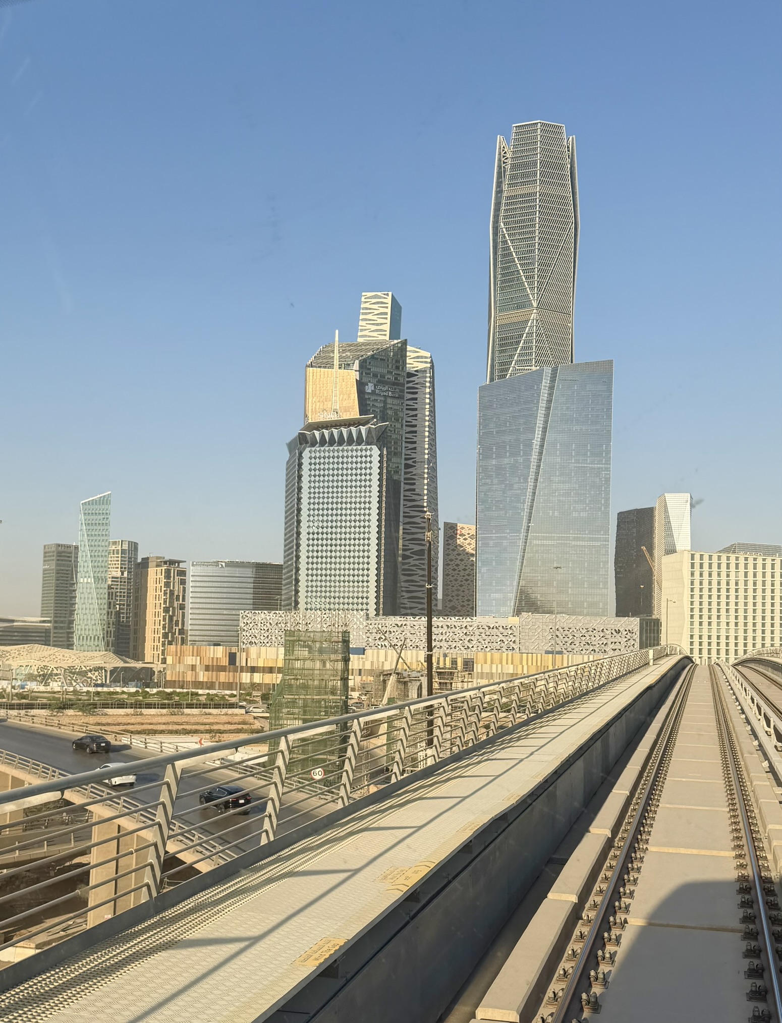 Modern Riyadh skyline with metro tracks and skyscrapers