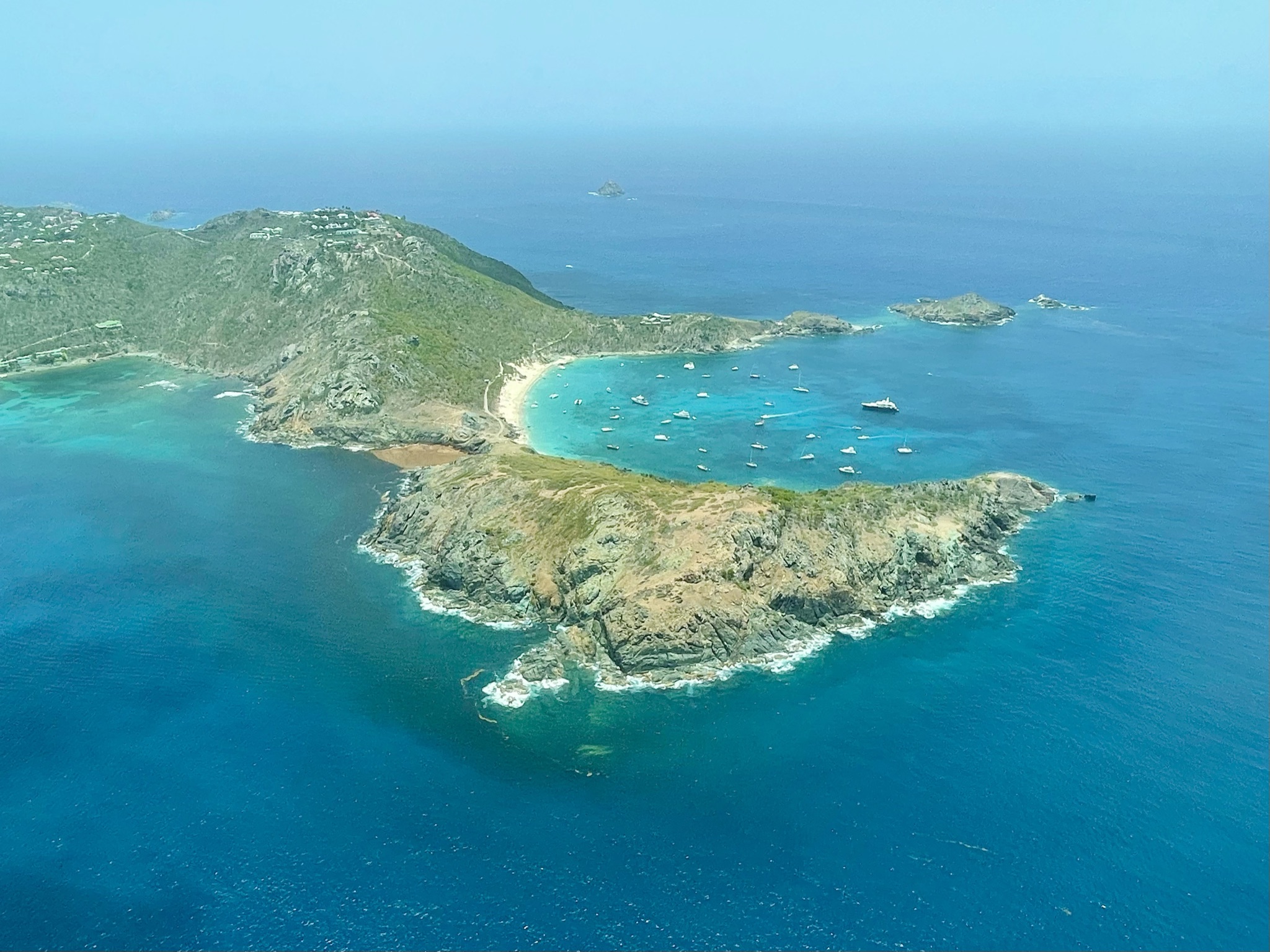 Aerial view of St. Barts coastline with turquoise waters and boats